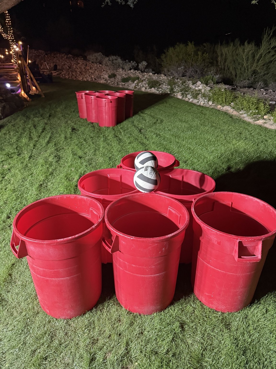 Giant Beer Pong buckets on a lawn