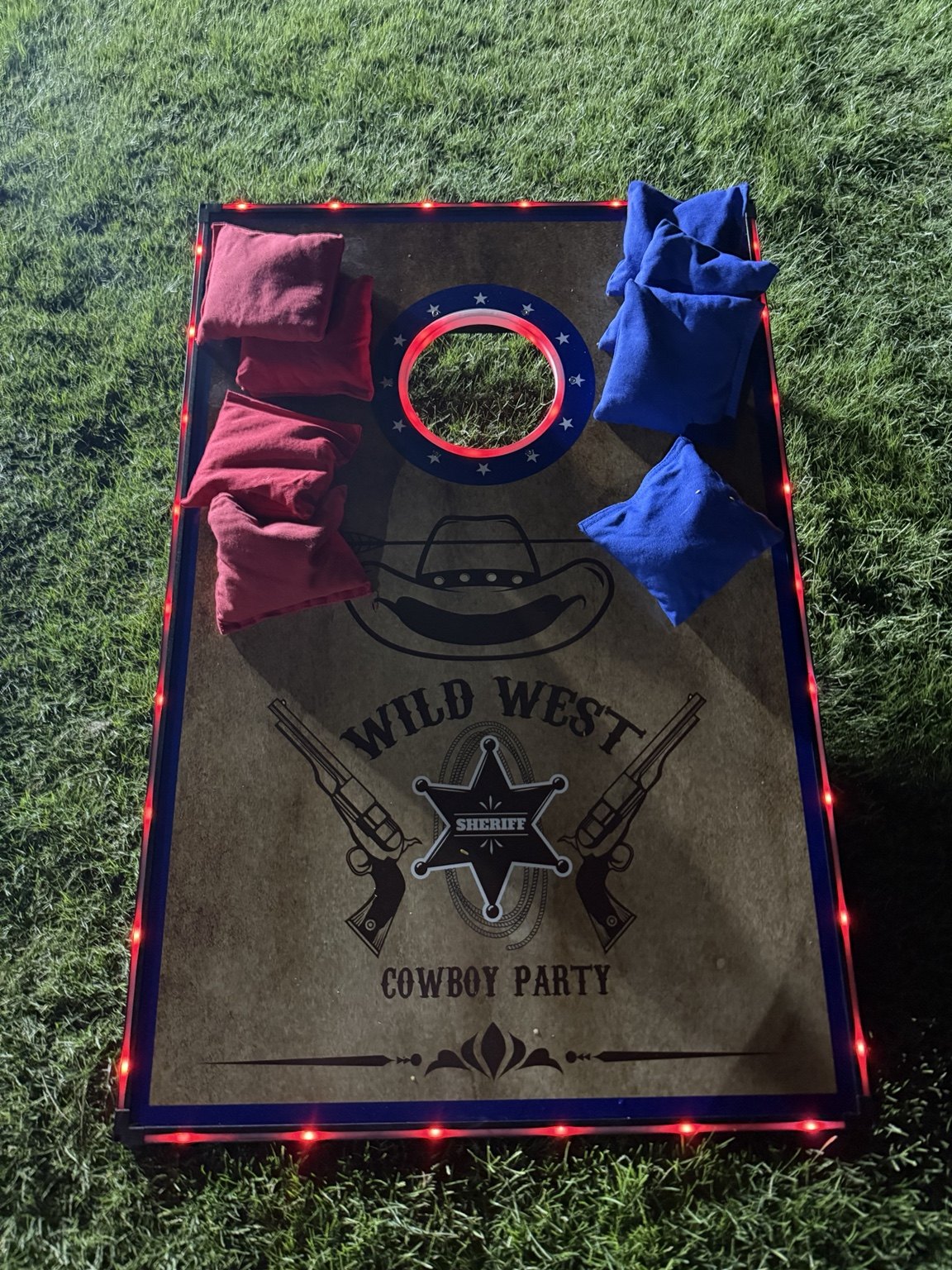 Western LED cornhole board on grass