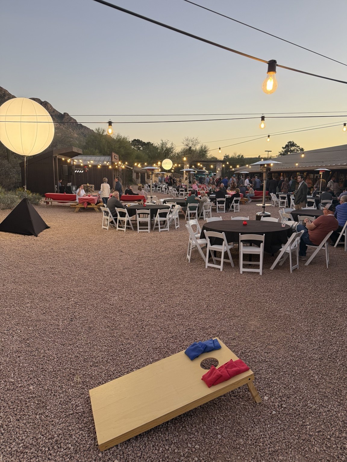 Regular cornhole at an outdoor evening event