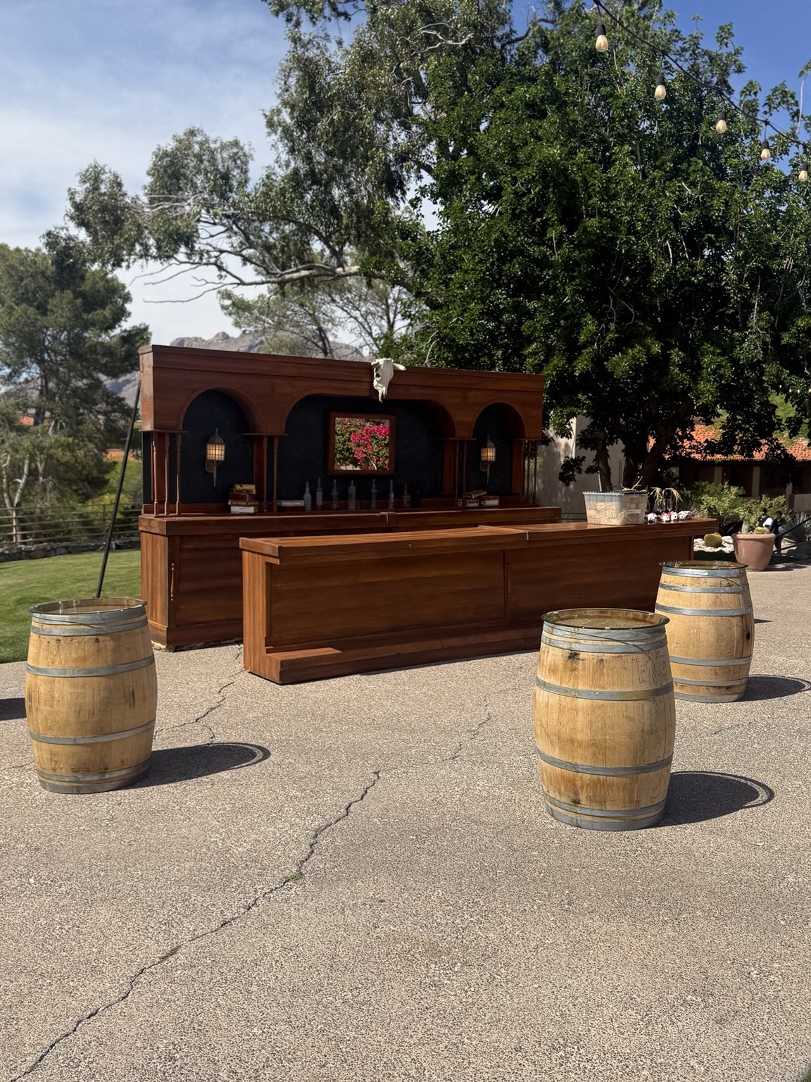 Whiskey barrels arranged around an outdoor bar