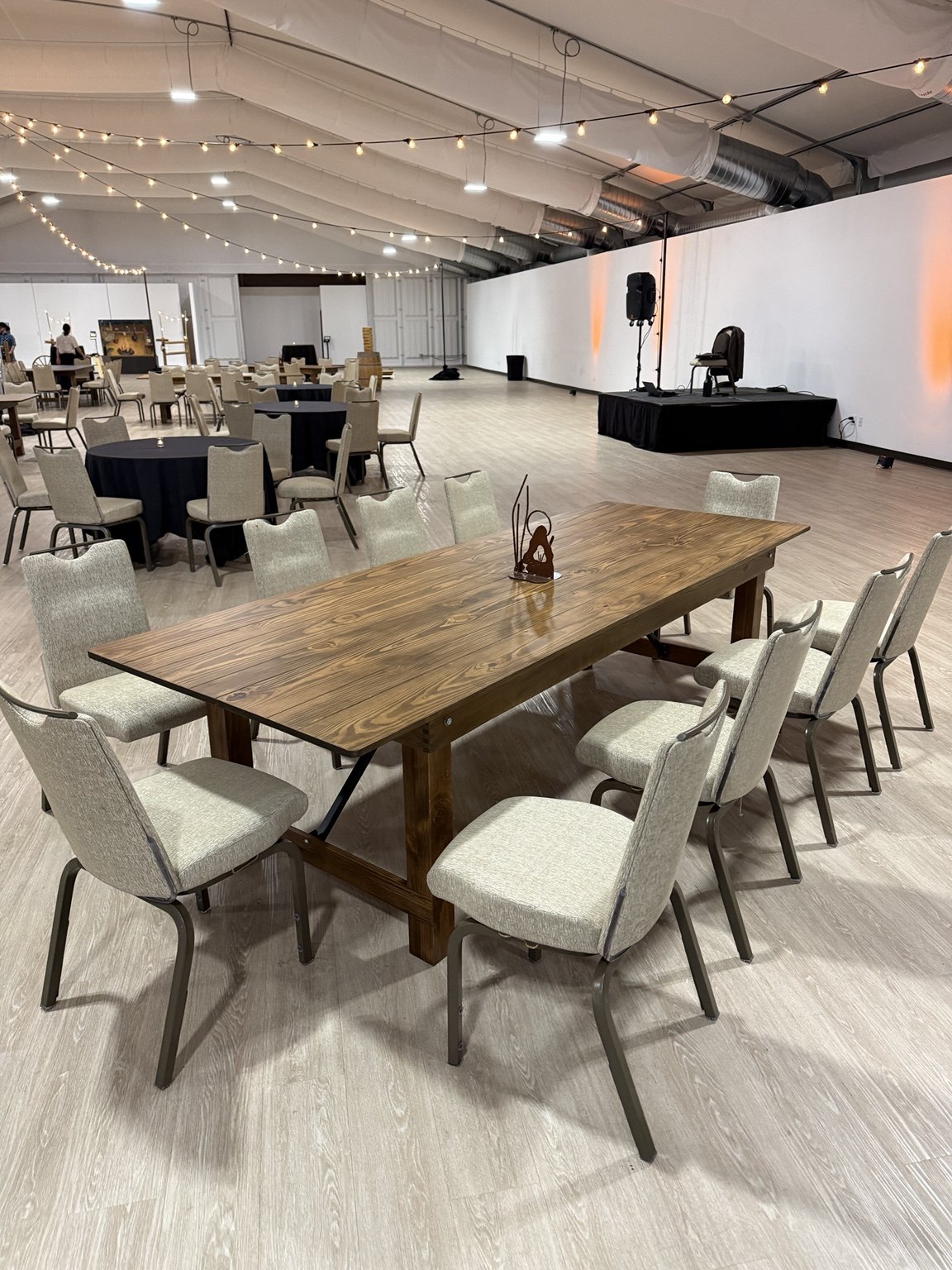 Set and Ready Rentals farm tables arranged inside an event tent