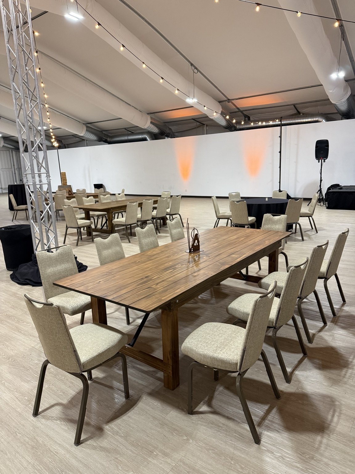 Farm tables arranged for an indoor event
