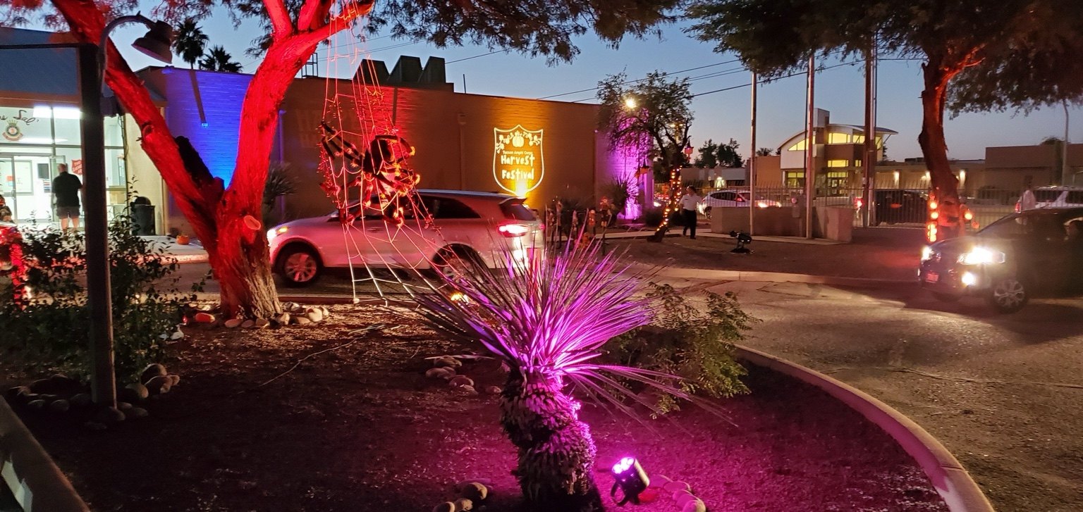 Red and purple uplighting at an outdoor evening event